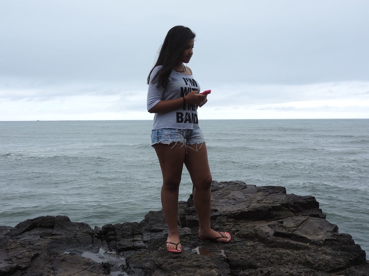 WOMAN STANDING ON BEACH