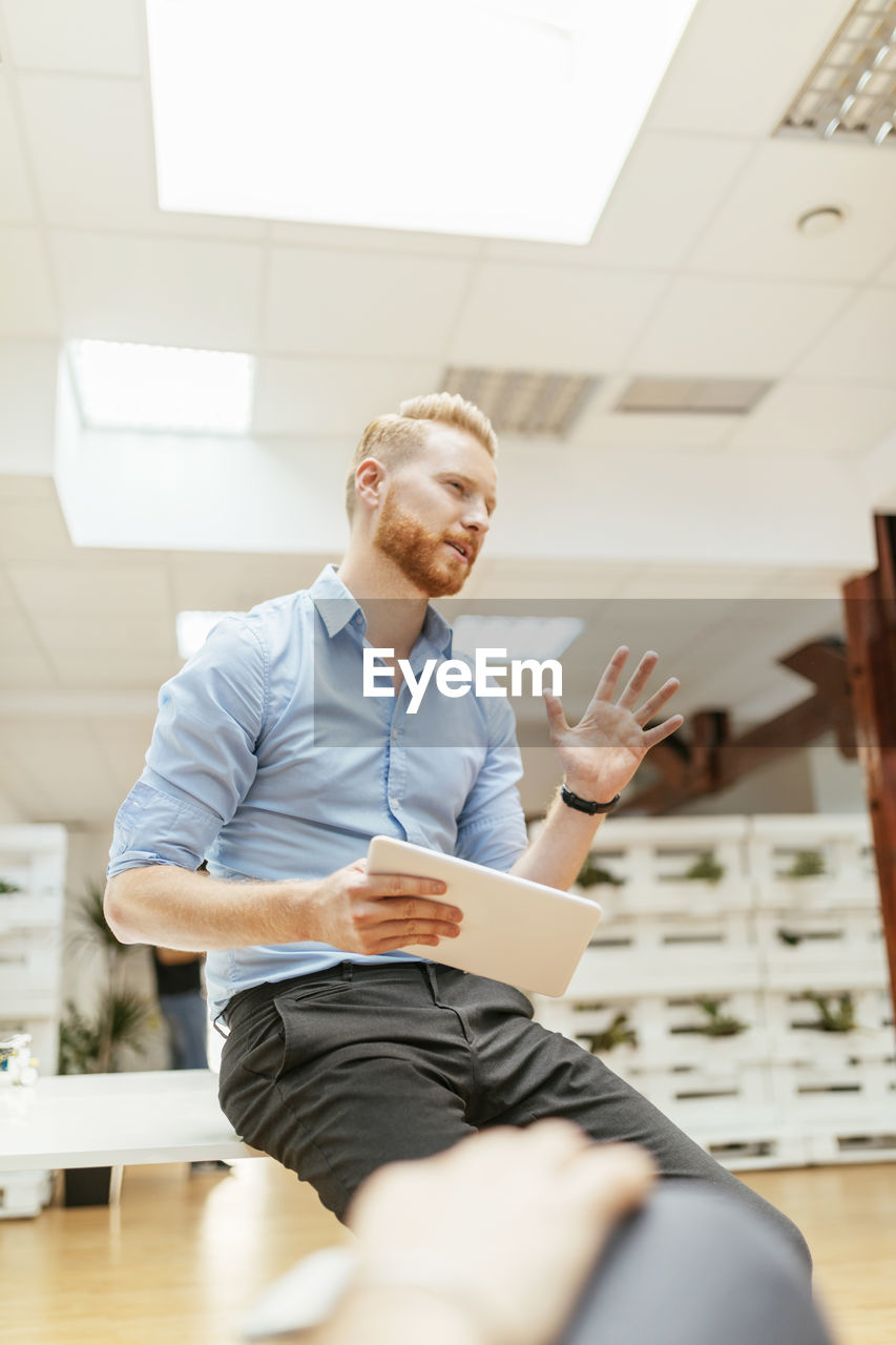 Businessman holding tablet during presentation