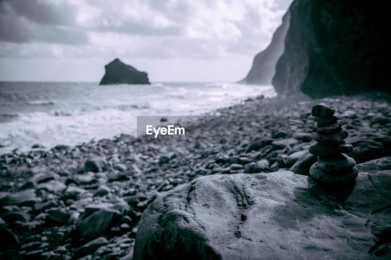 Rocks on beach against sky