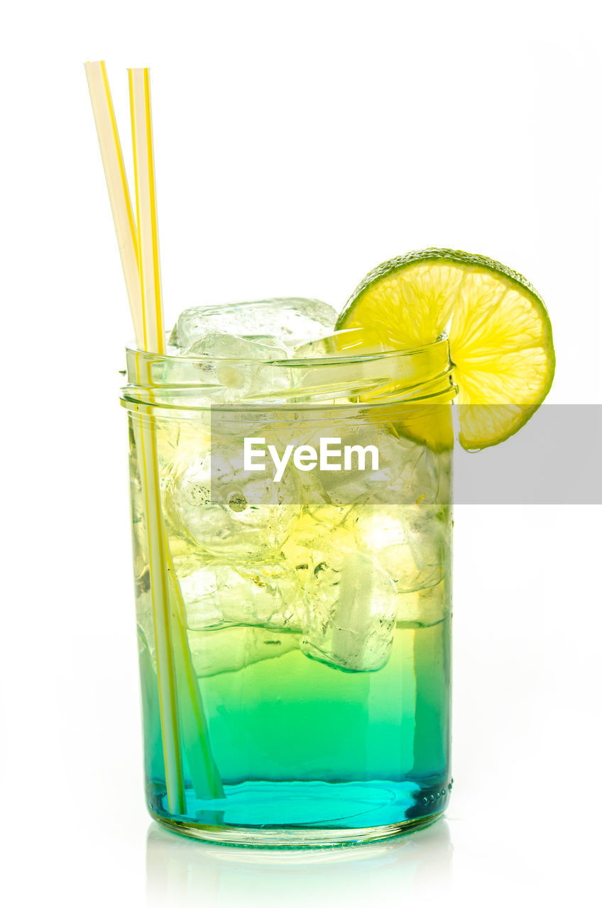 Drink with ice cubes and lemon slice on white background, isolated