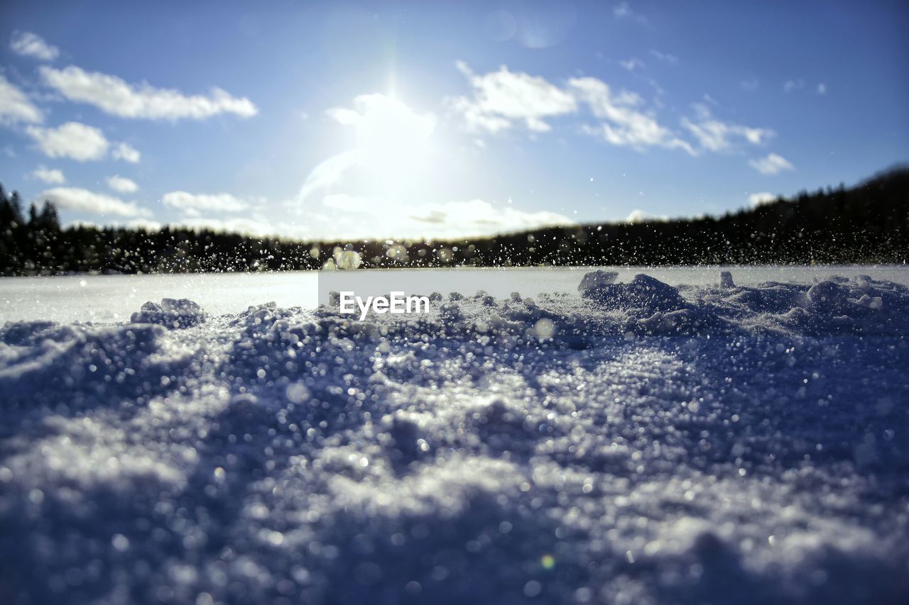 Snow covered landscape against sky