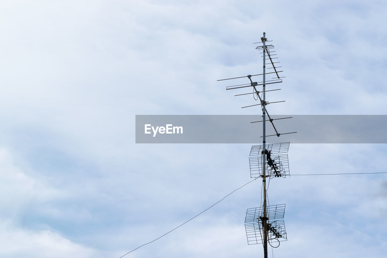 Low angle view of electricity pylon or aerial against sky