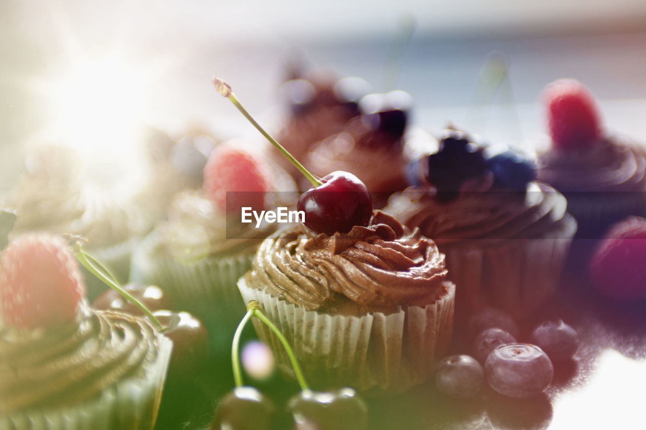 Close-up of cherry on cupcake at table