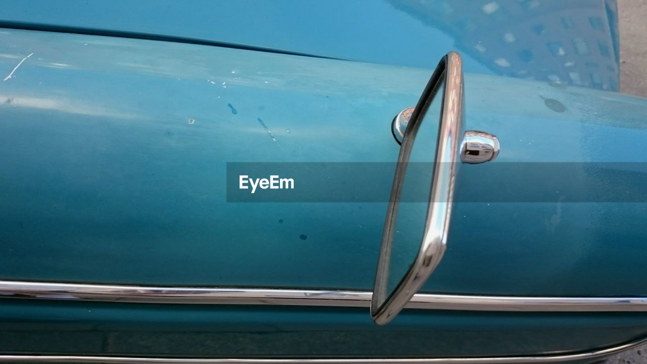 Blue car detail with rear-view mirror