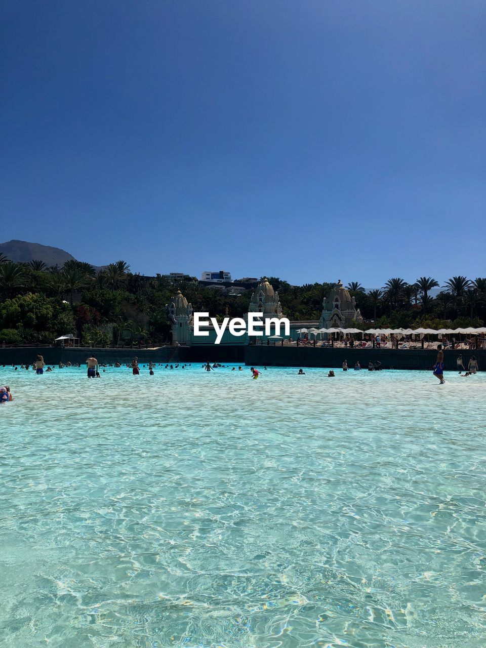 Scenic view of swimming pool against clear blue sky