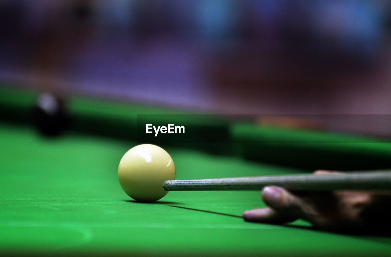 Cropped hand playing pool