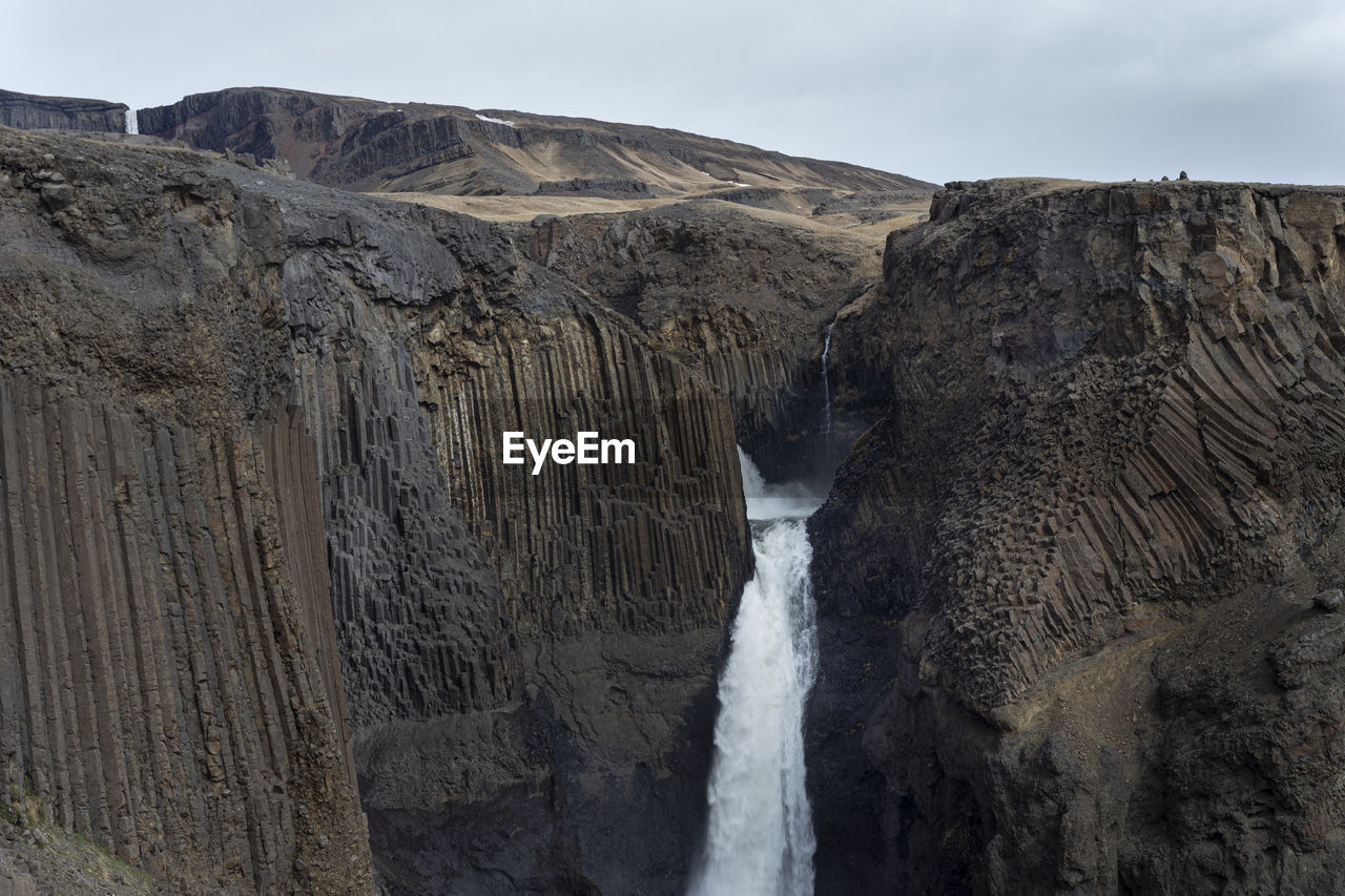 Landscape of the waterfall litlanesfoss among the basalt rocks