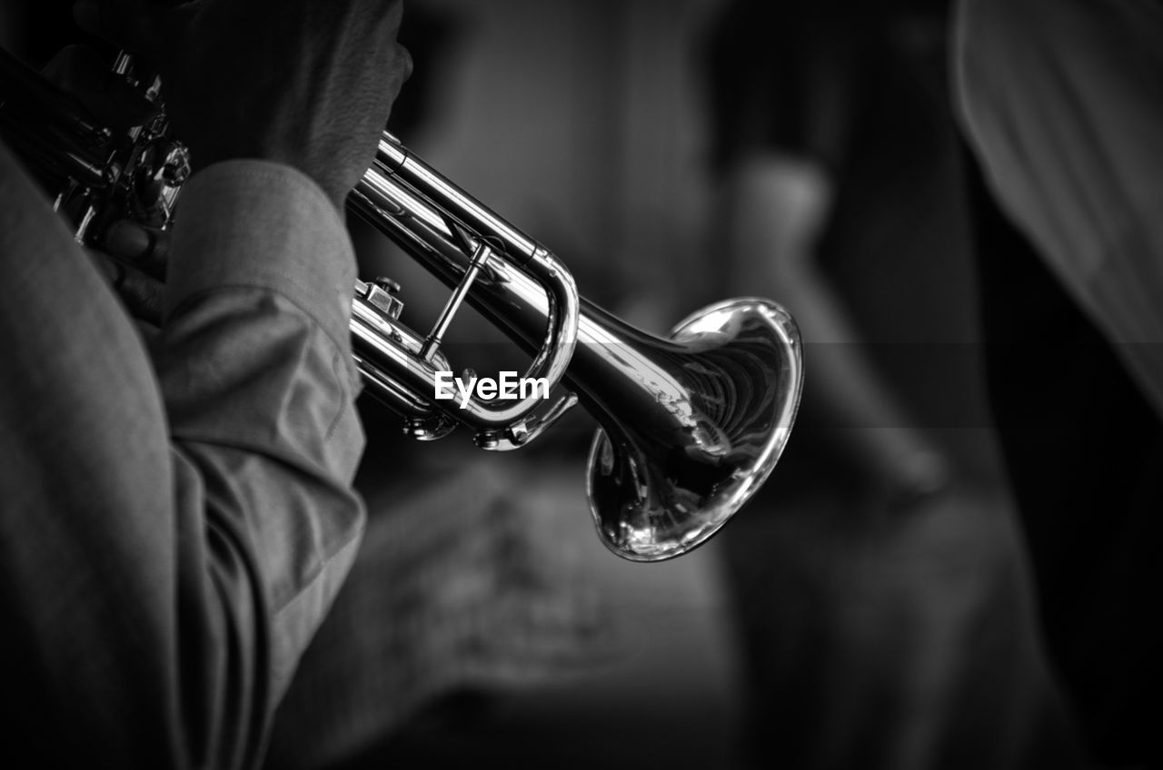 Cropped hand playing trumpet