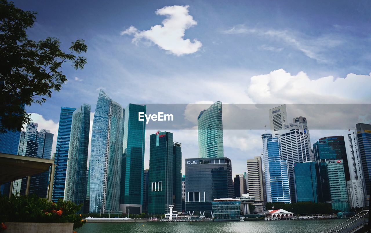 Skyscrapers against cloudy sky