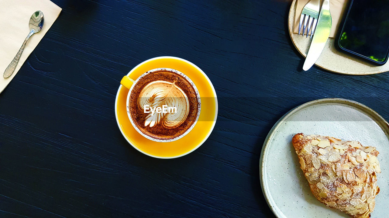 High angle view of cappuccino served on table