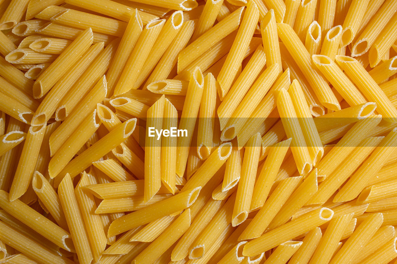 italian food, food, pasta, food and drink, raw food, freshness, large group of objects, yellow, healthy eating, cuisine, abundance, fast food, dish, full frame, wellbeing, still life, backgrounds, indoors, no people, close-up, penne, high angle view, french fries, produce