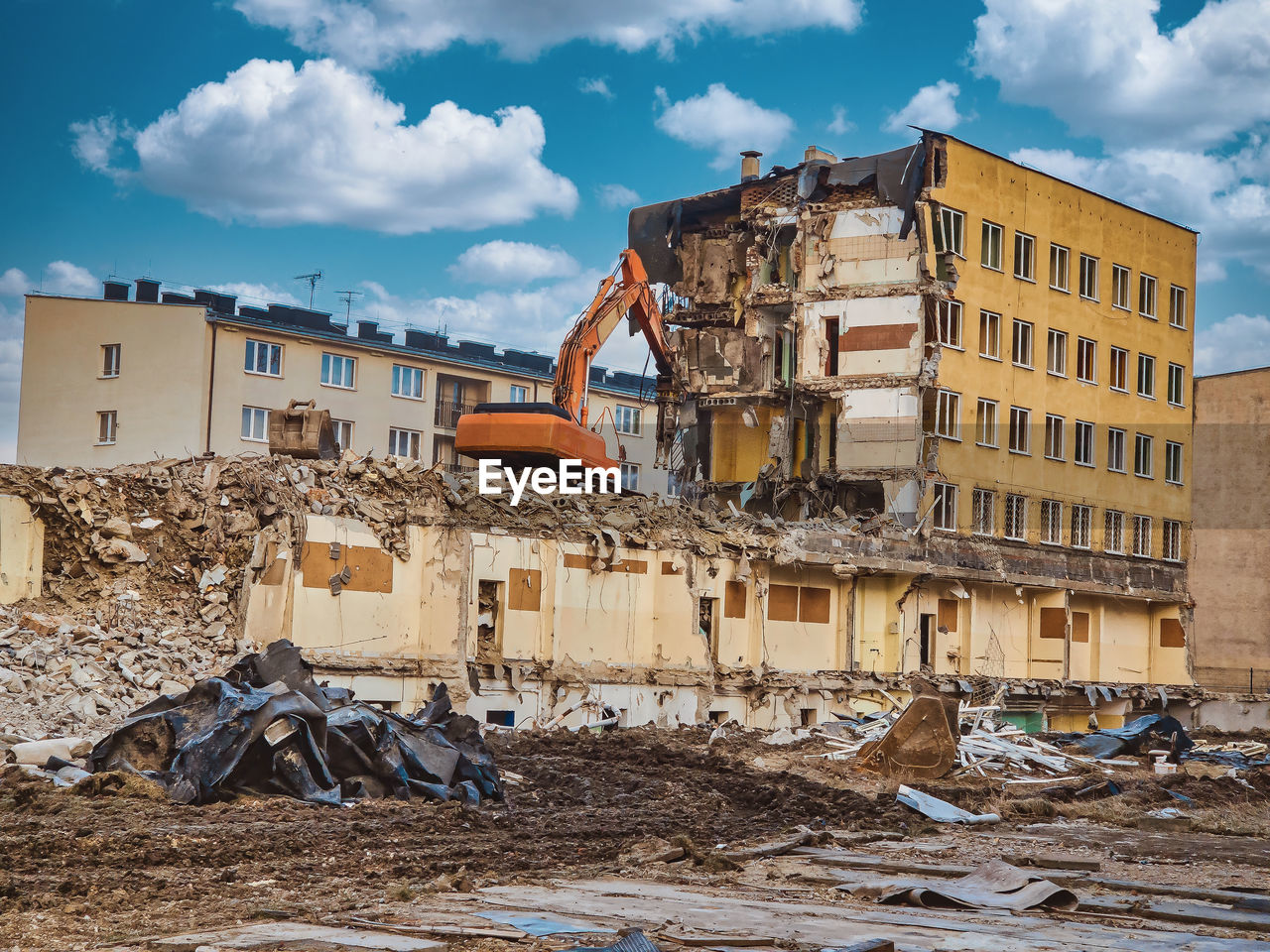 Yellow excavator destroys armored concrete to open doors new possibilities