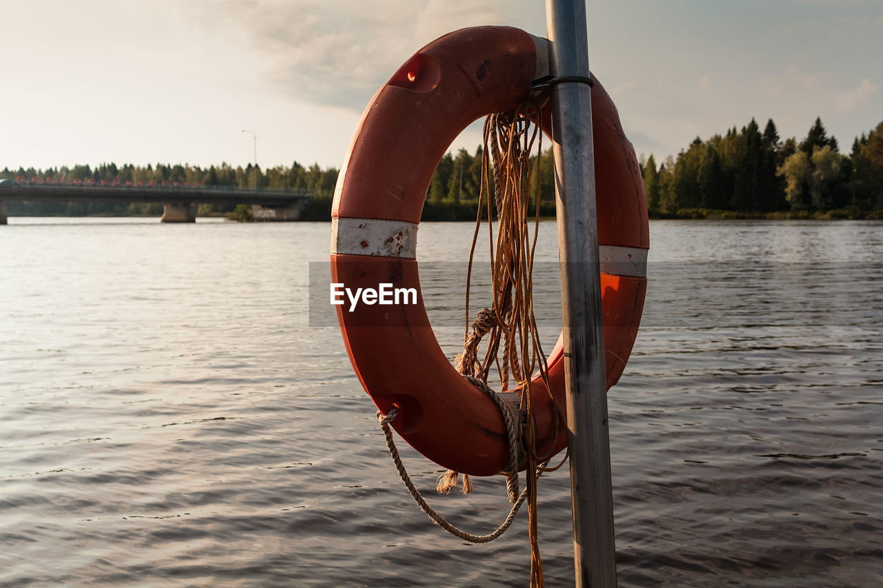 A lifebelt hanging by a lake on an early autumn morning at the northern finland. 