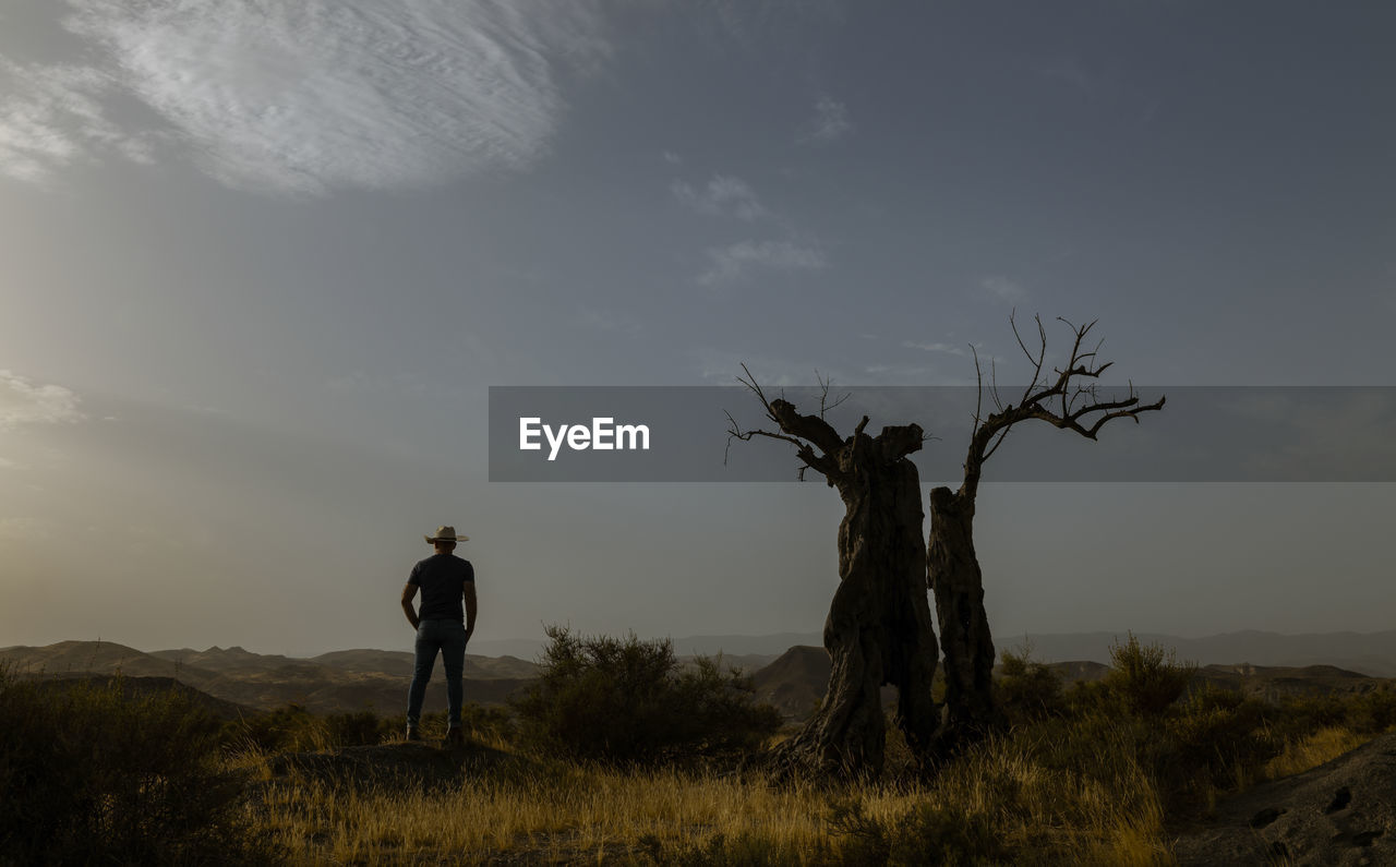 Silhouette of adult man standing on desert during sunset. almeria, spain