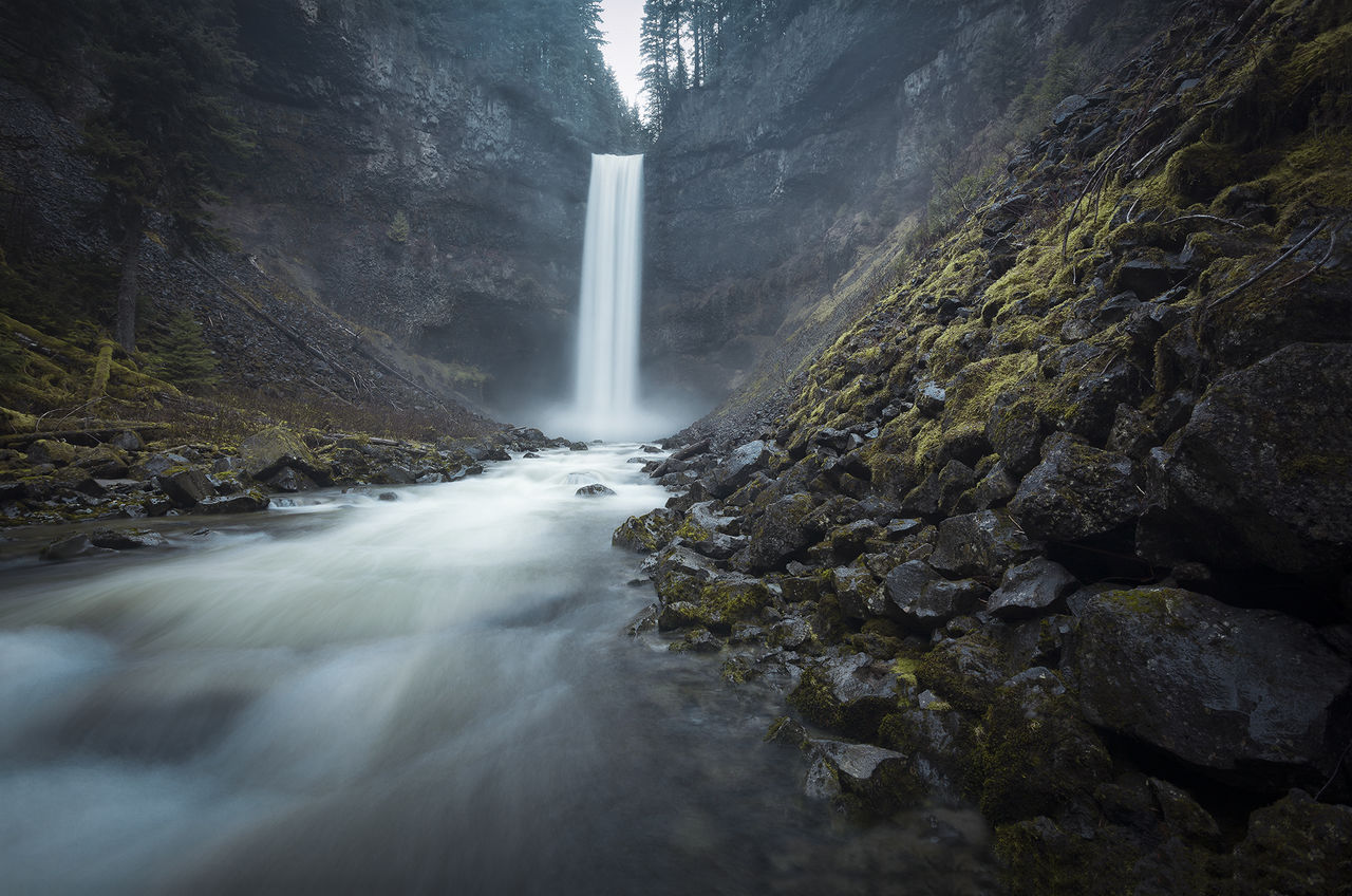 VIEW OF WATERFALL WITH RAINBOW OVER RIVER