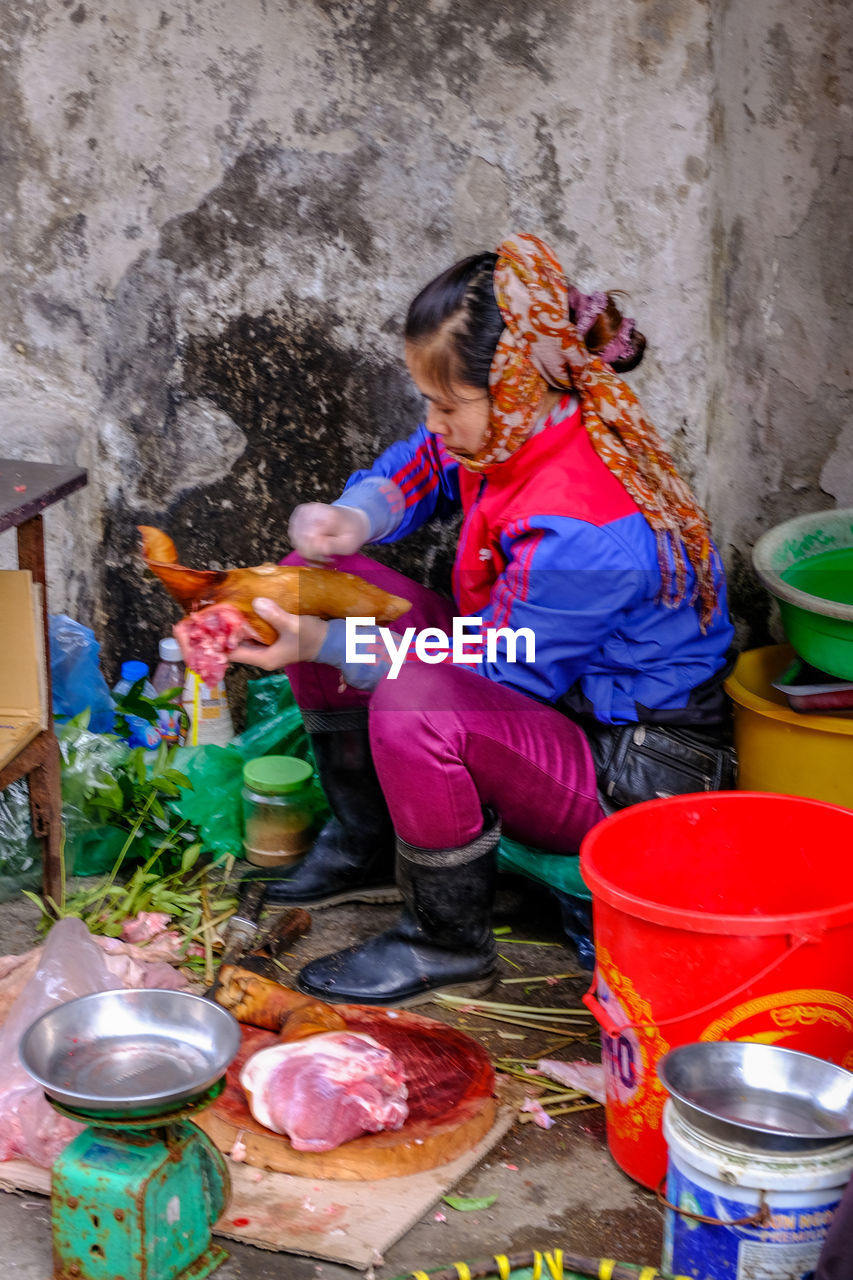 SIDE VIEW OF A GIRL SITTING IN BOWL WITH WATER