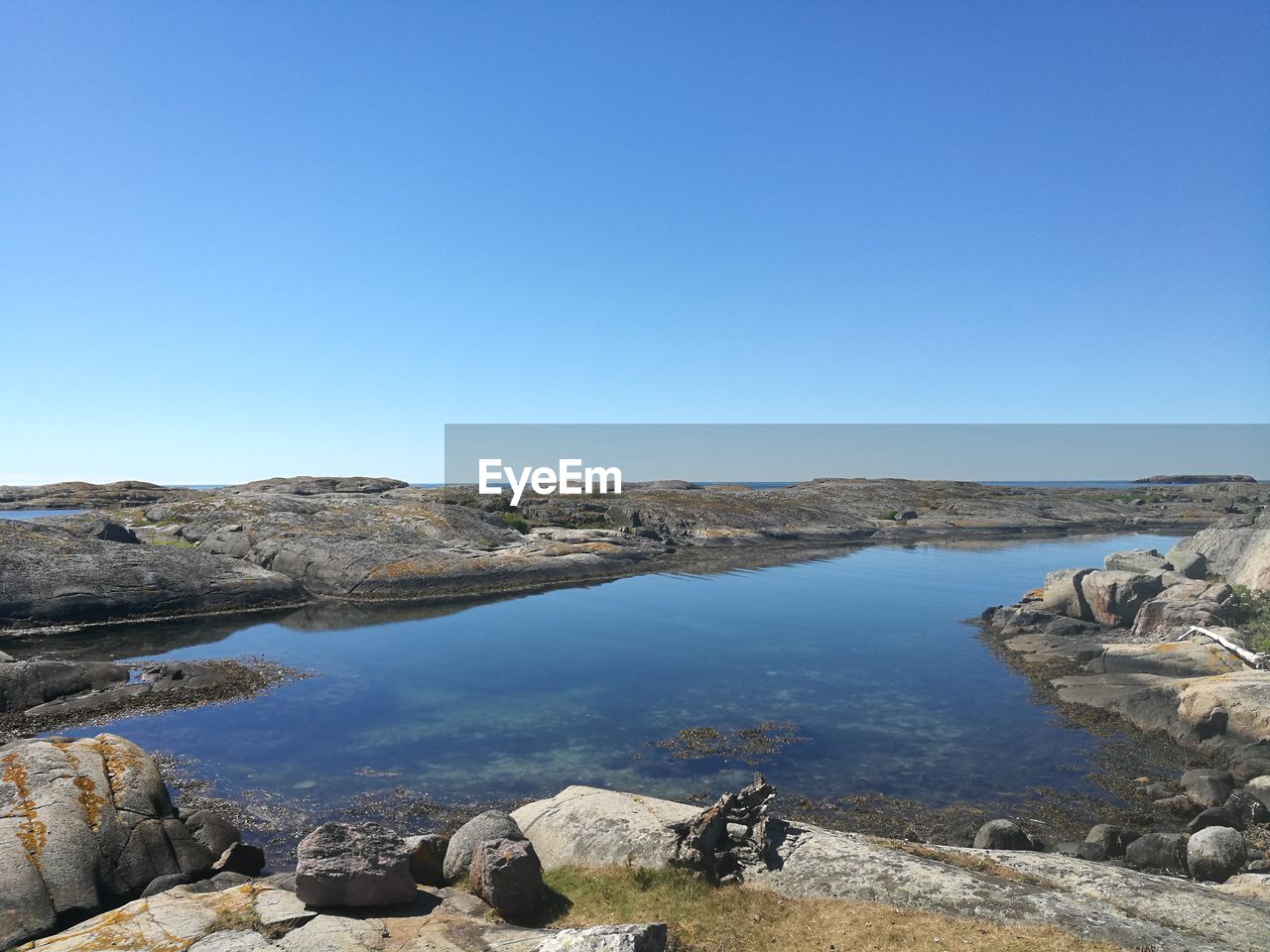 Scenic view of sea against clear blue sky