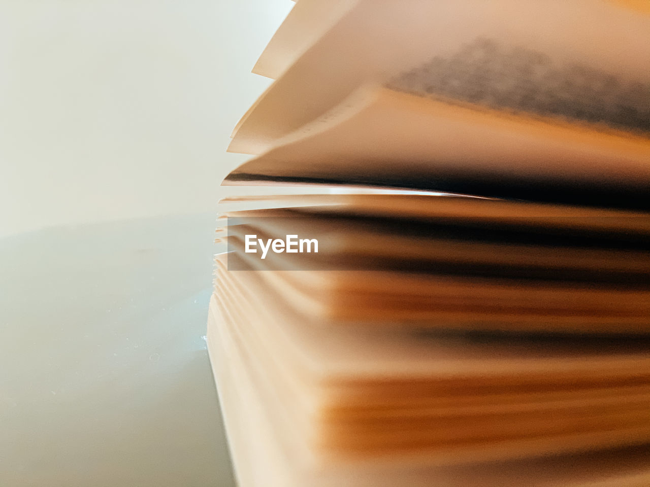 HIGH ANGLE VIEW OF BOOKS ON TABLE AGAINST WHITE BACKGROUND