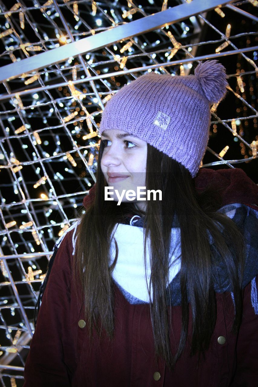 PORTRAIT OF YOUNG WOMAN WEARING HAT