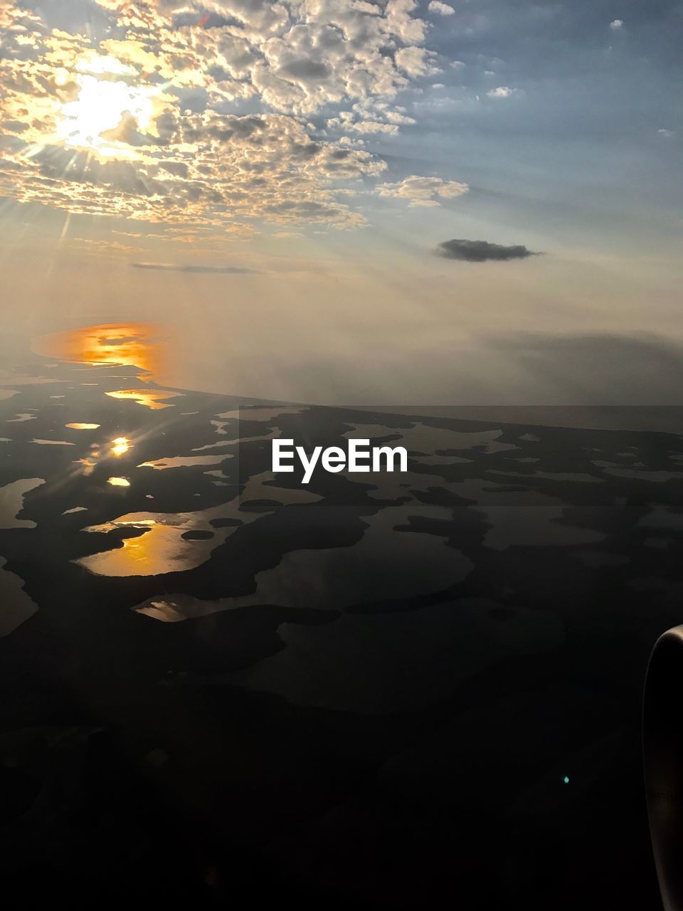 CLOSE-UP OF LANDSCAPE AGAINST SUNSET SKY