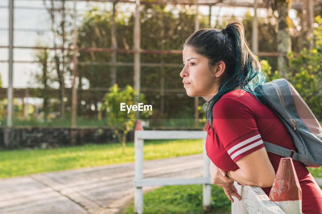 Beautiful young student, anxious and serious, waiting for the order she placed online