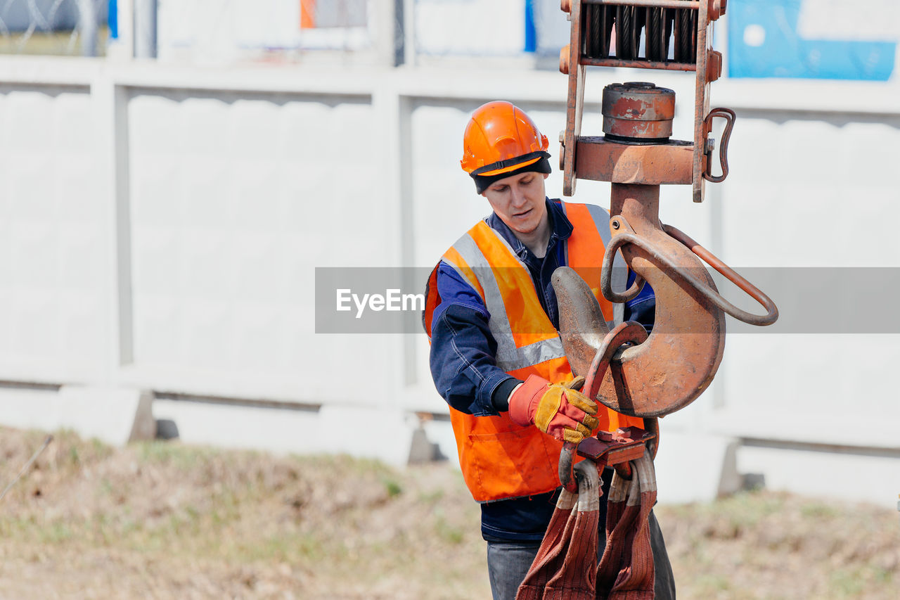 Side view of man working at construction site