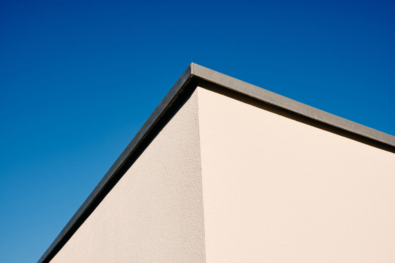 Low angle view of building against clear blue sky