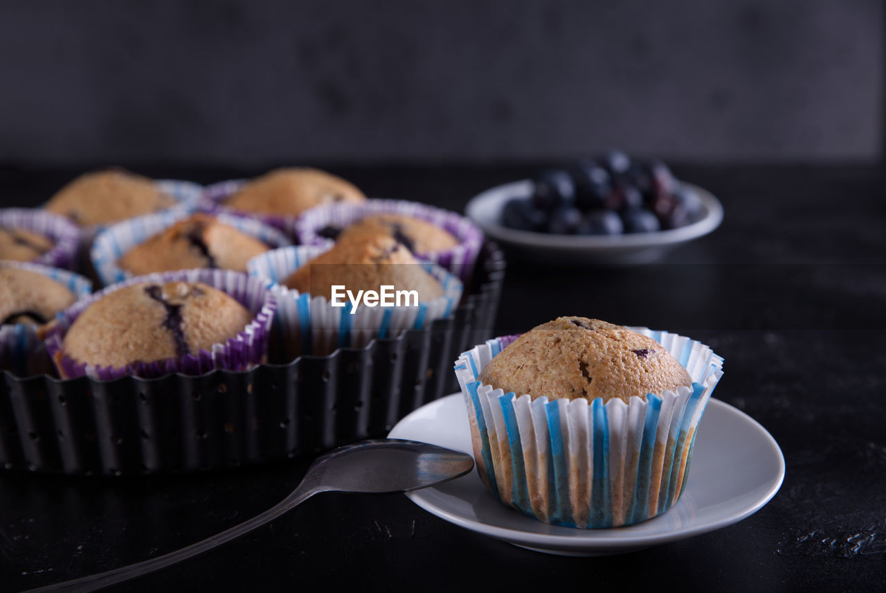 Delicious homemade cupcakes filled with blueberries and presented in small molds.