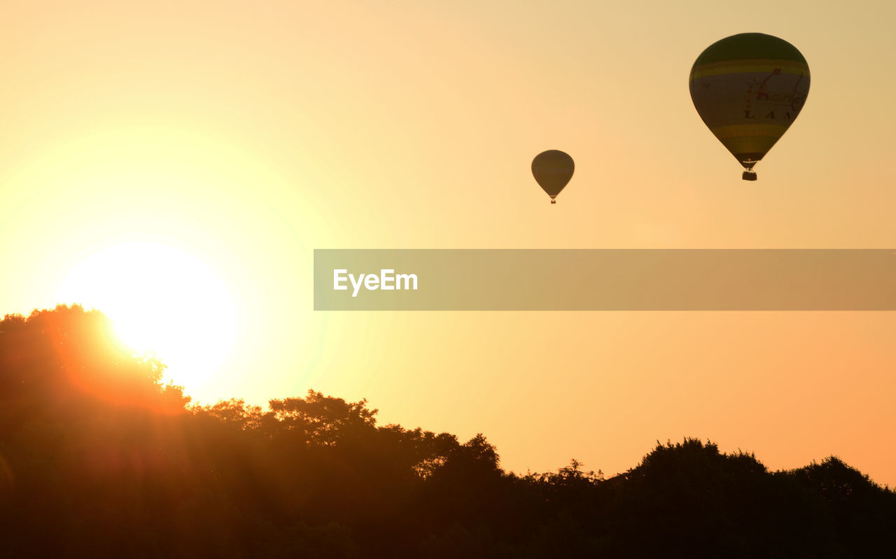 SILHOUETTE OF HOT AIR BALLOON AGAINST SKY DURING SUNSET