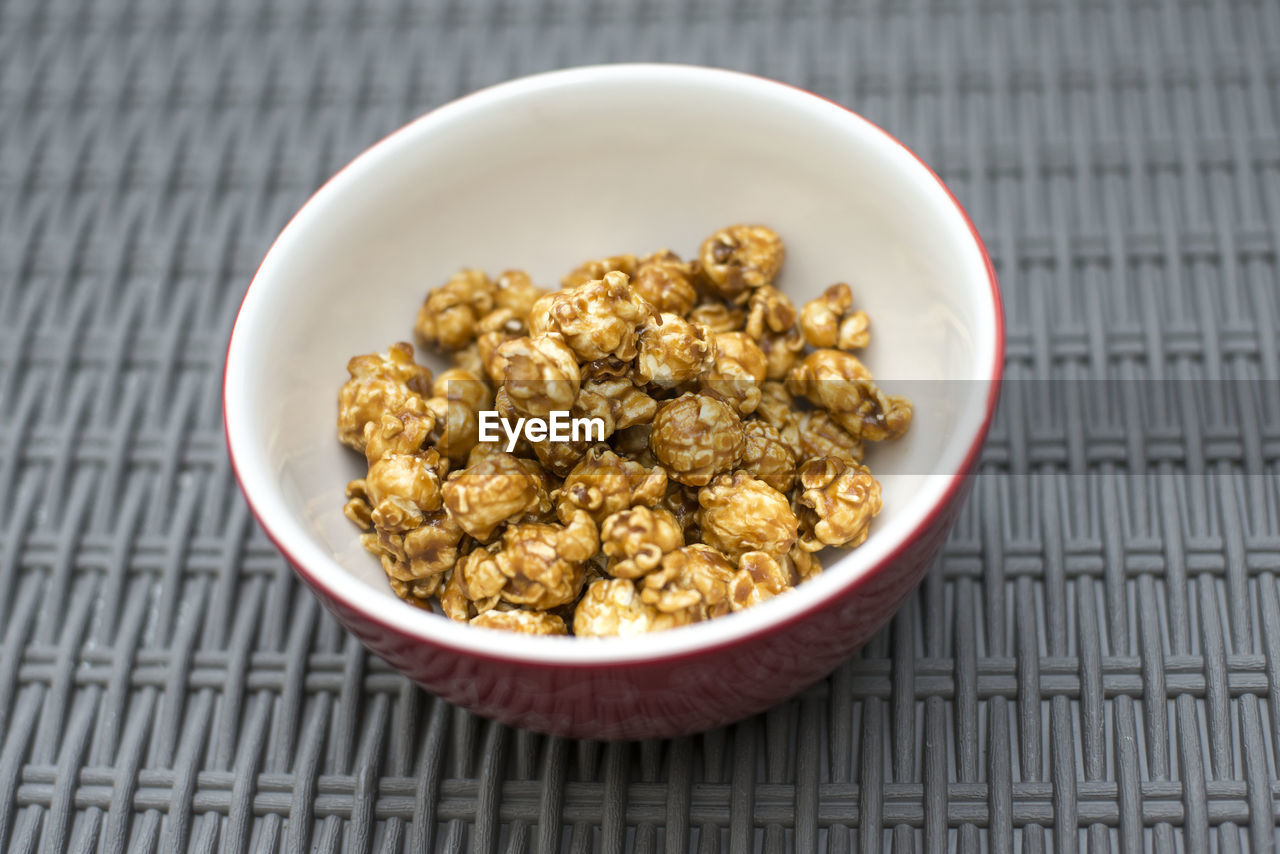 Close-up of caramel corn in bowl on table
