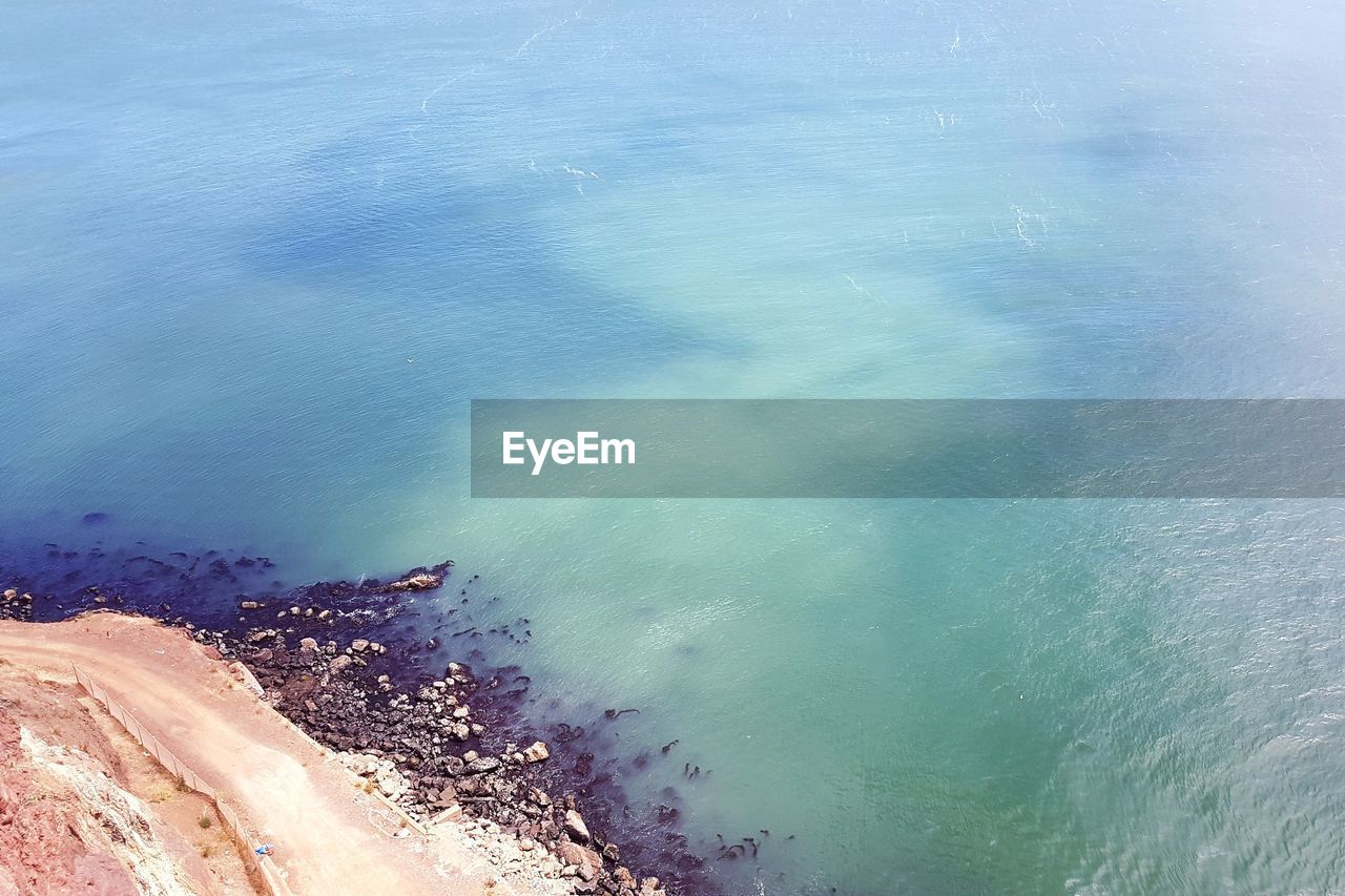 HIGH ANGLE VIEW OF BEACH AGAINST BLUE SKY