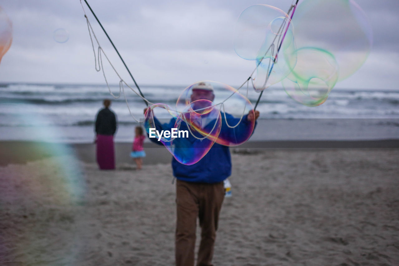 Man making bubbles at beach