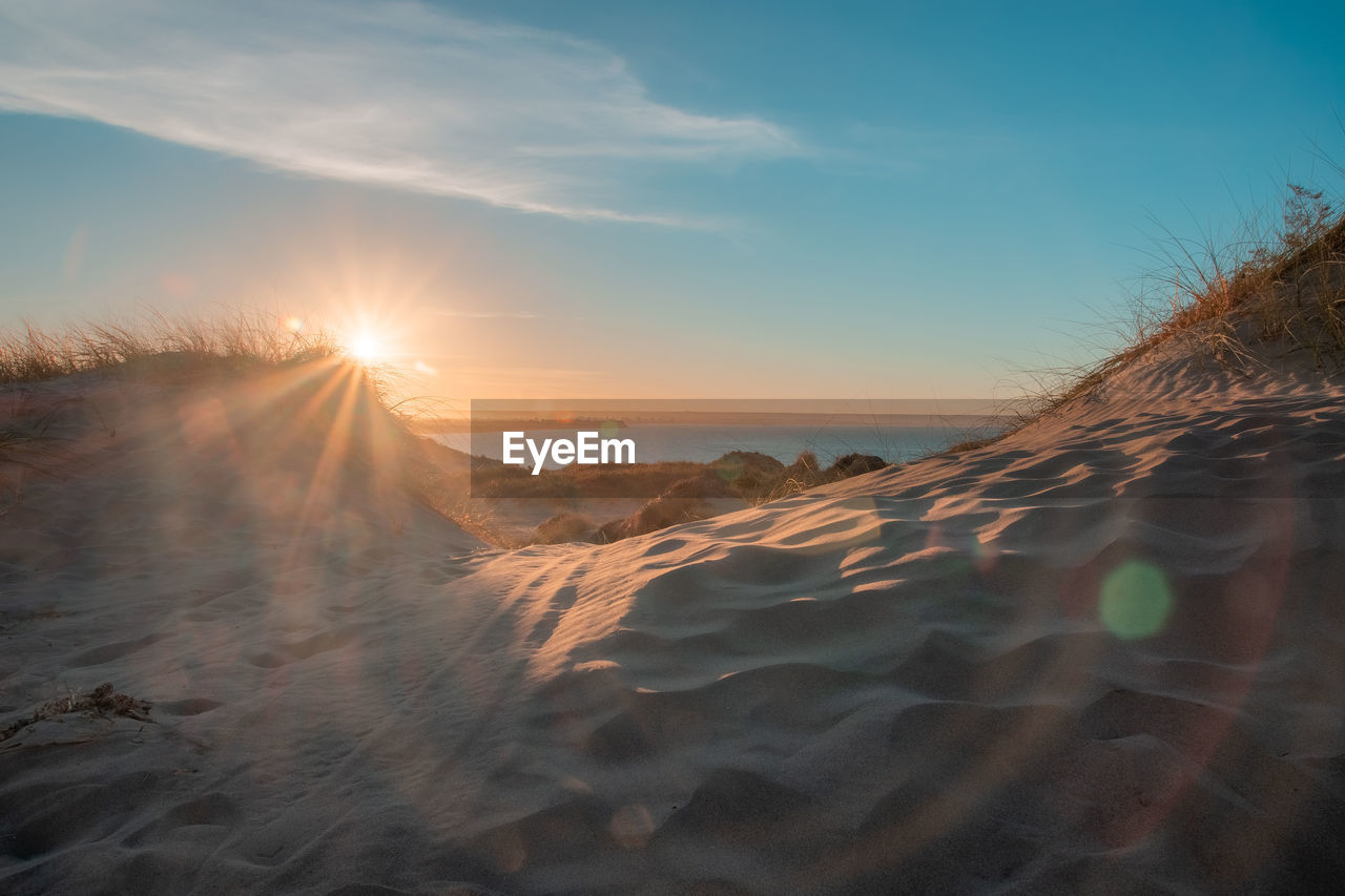 Scenic view of land against sky during sunset