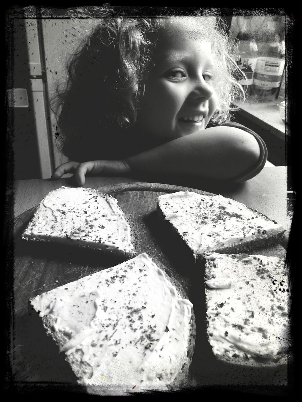 Cake slices on table in front of happy girl