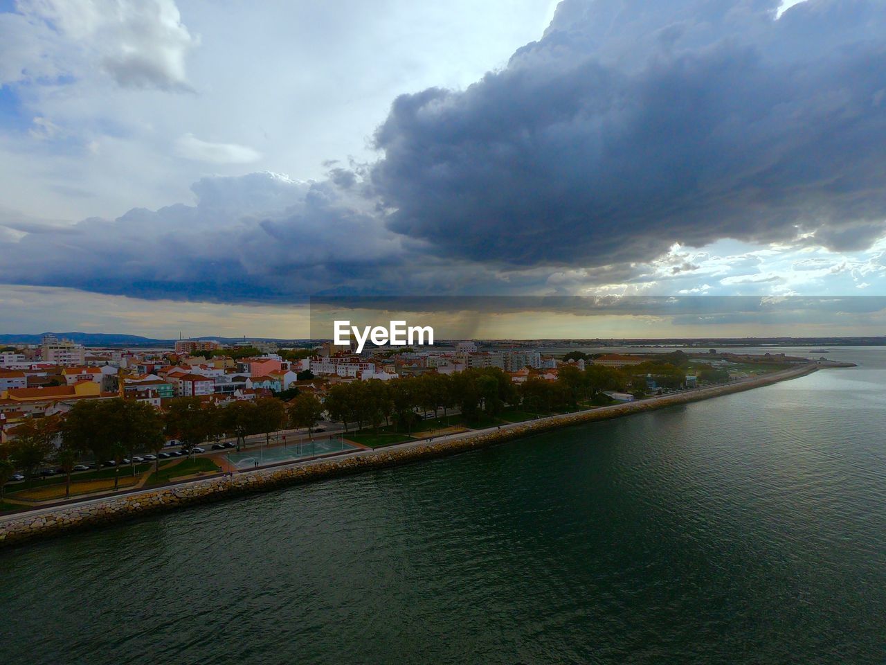 River amidst buildings in city against sky