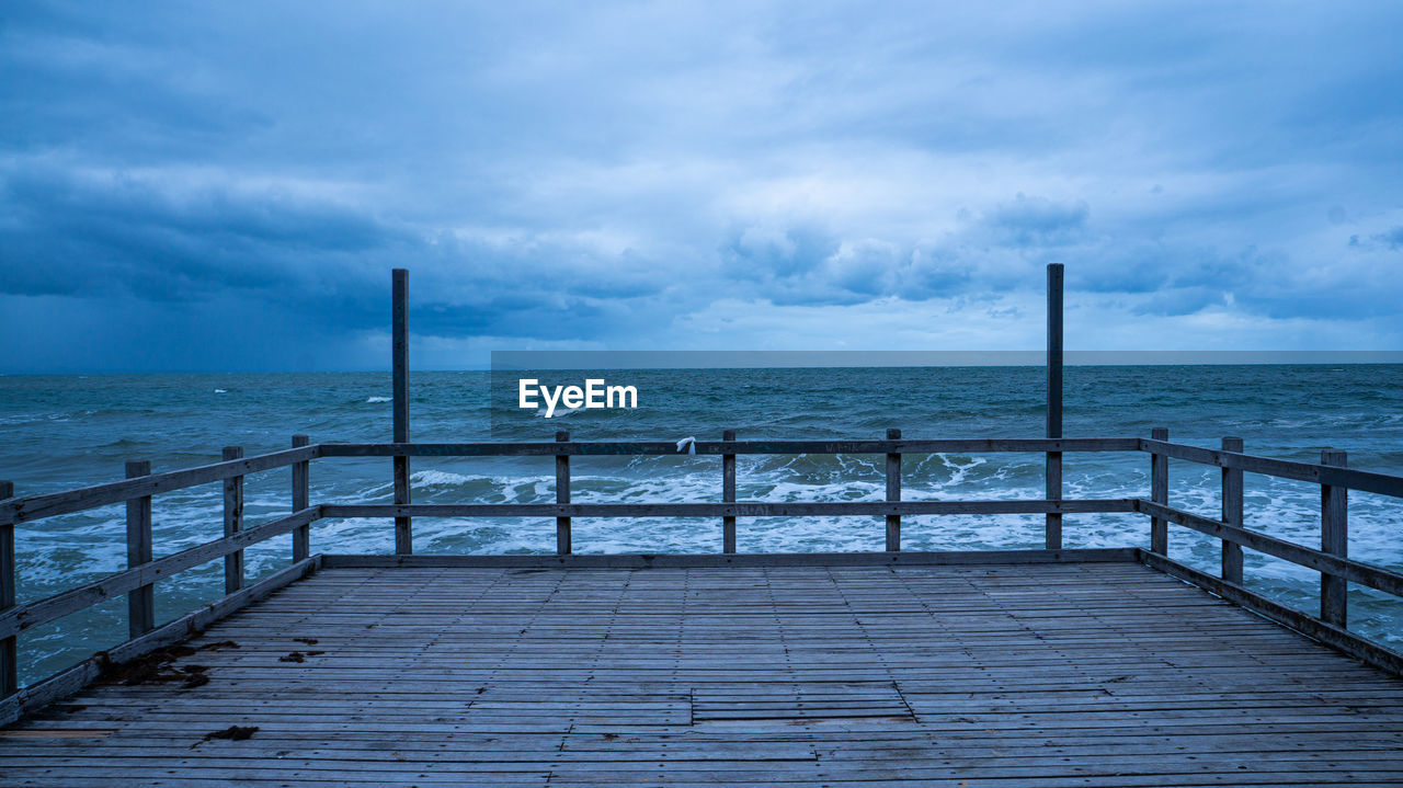 Pier over sea against sky