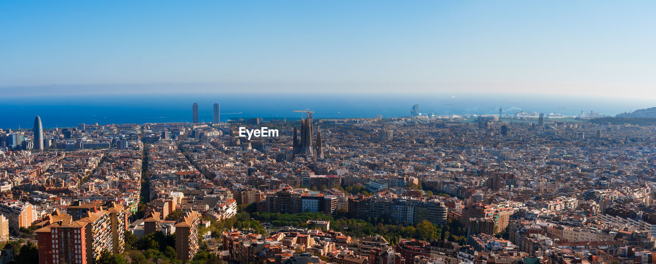 Panoramic view of barcelona with sagrada familia and mediterranean sea