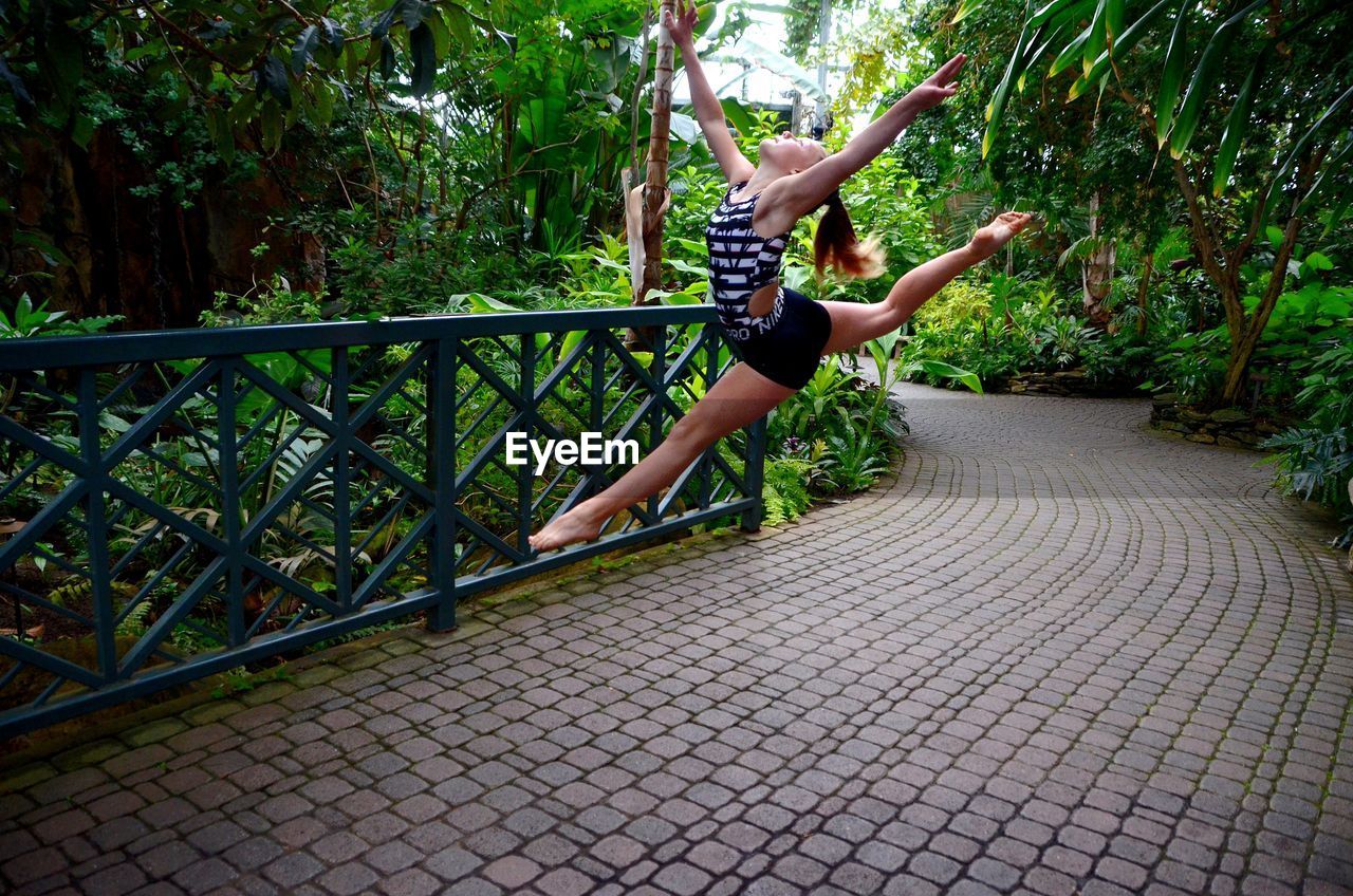 Athlete leaping in garden 