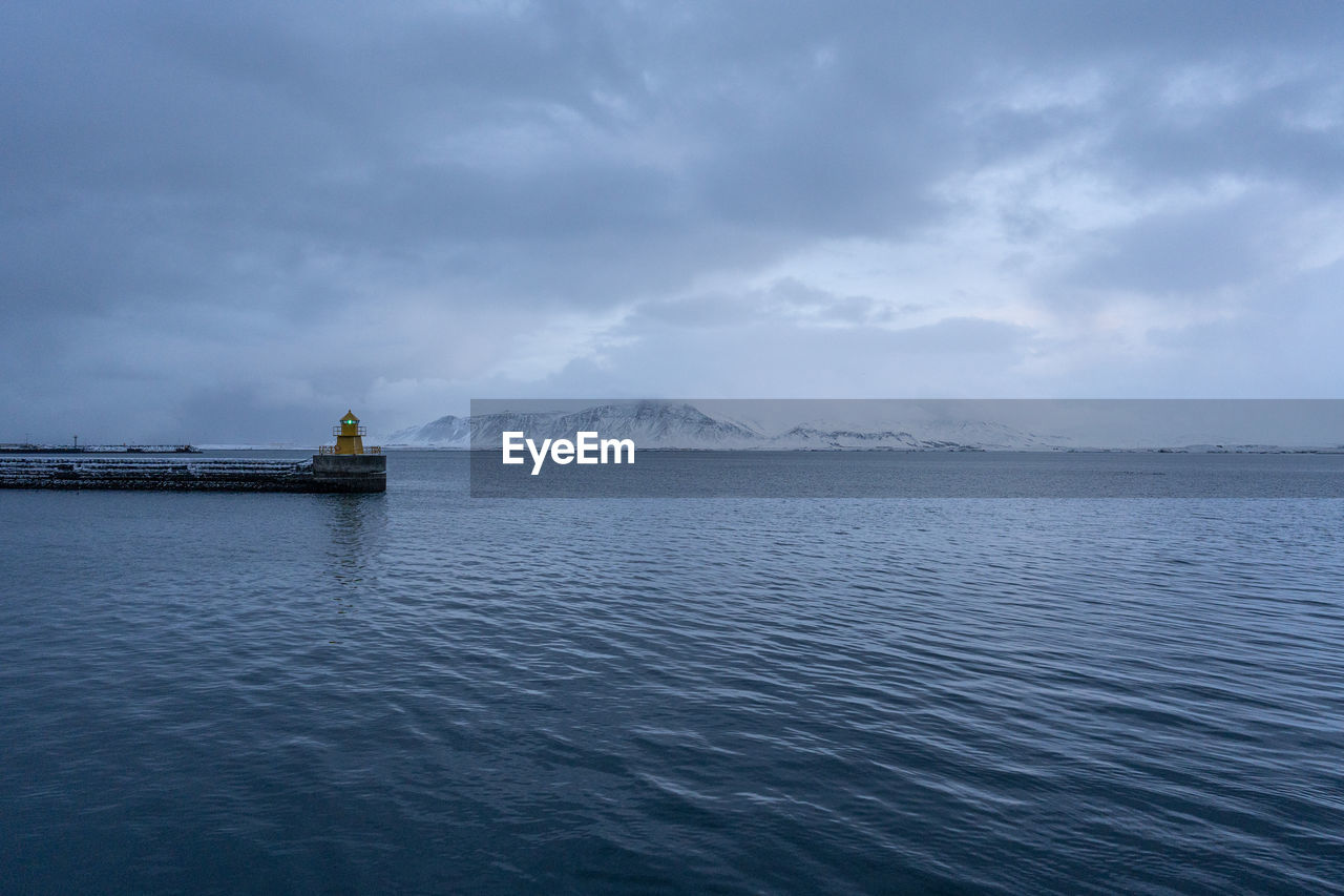 scenic view of sea against cloudy sky