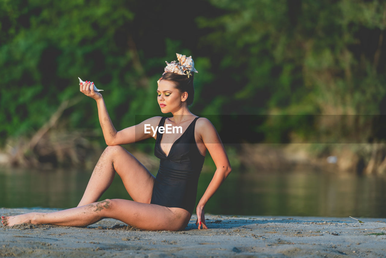 Full length of young woman in lake