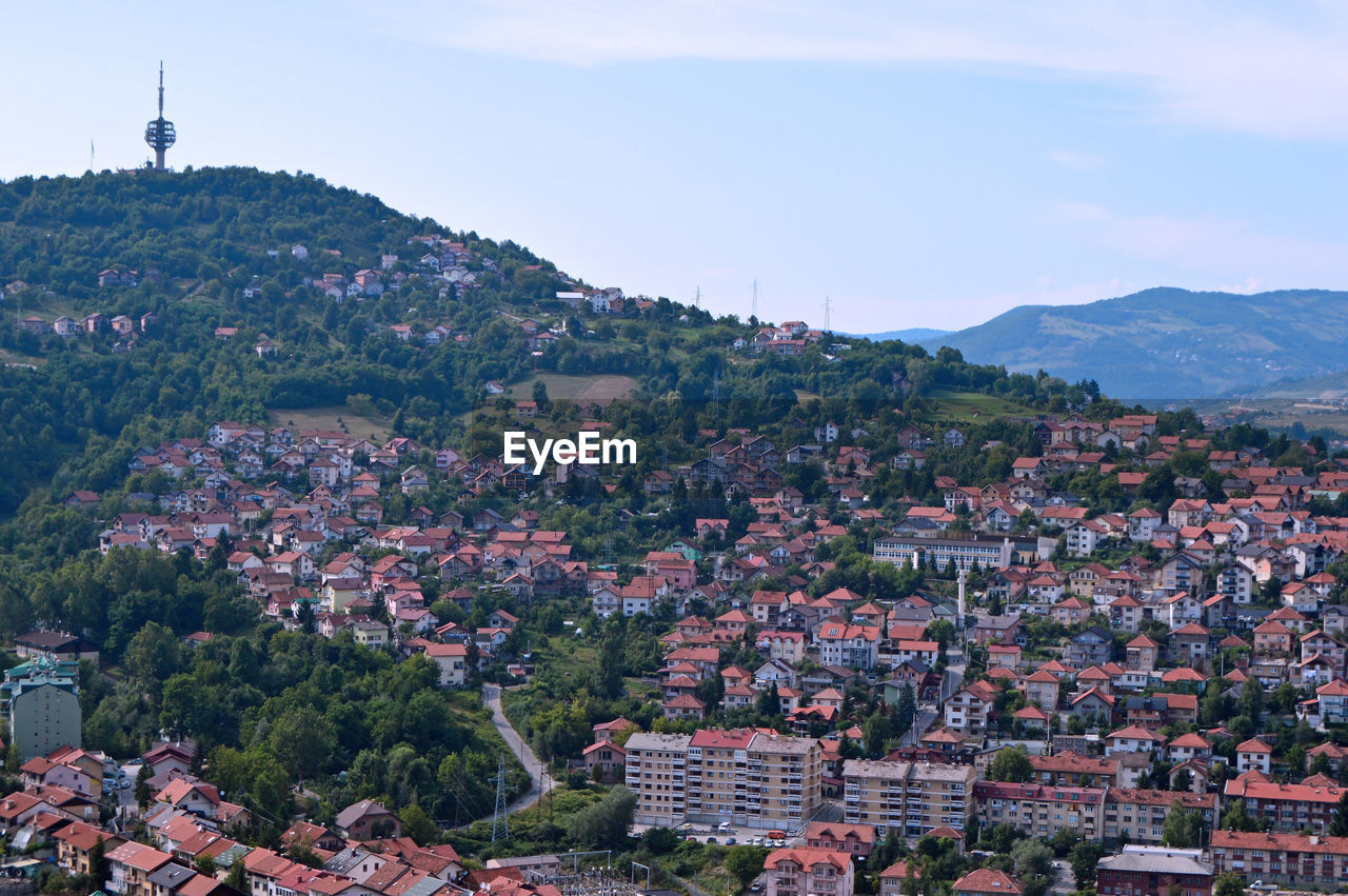 Buildings in town against sky