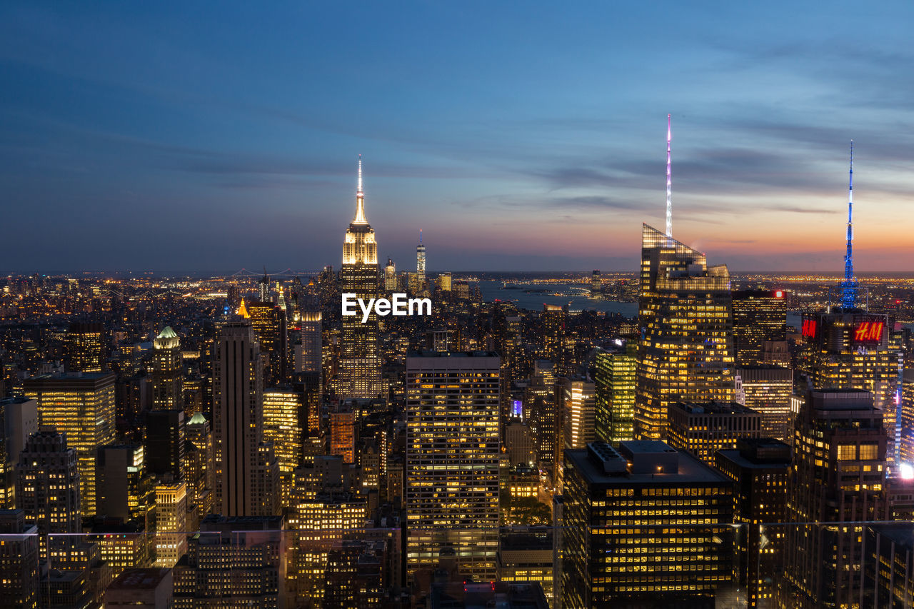 Illuminated cityscape against sky at night