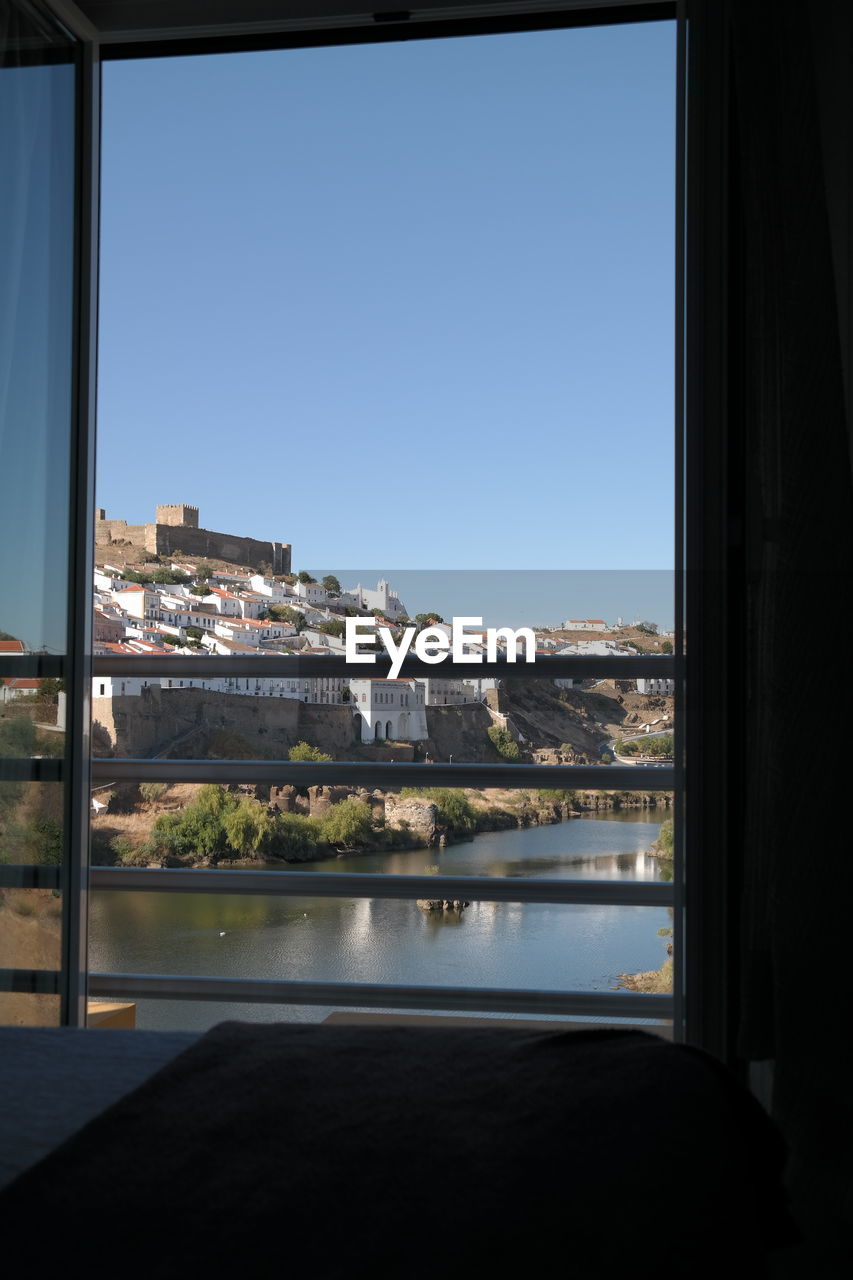 View of cityscape seen through window