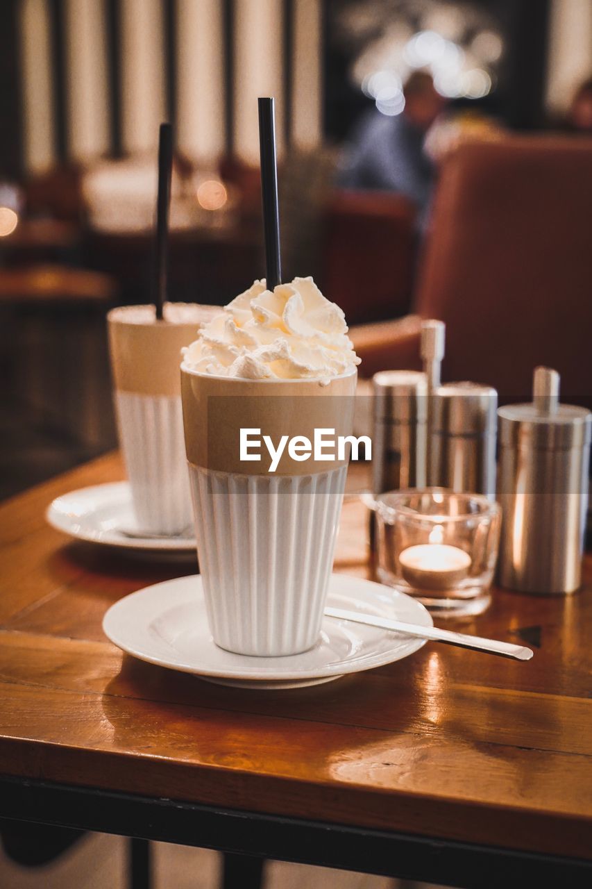 Close-up of drinks served on table at cafe