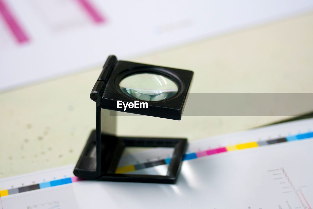 Close-up of diamond checking magnifying glass on table