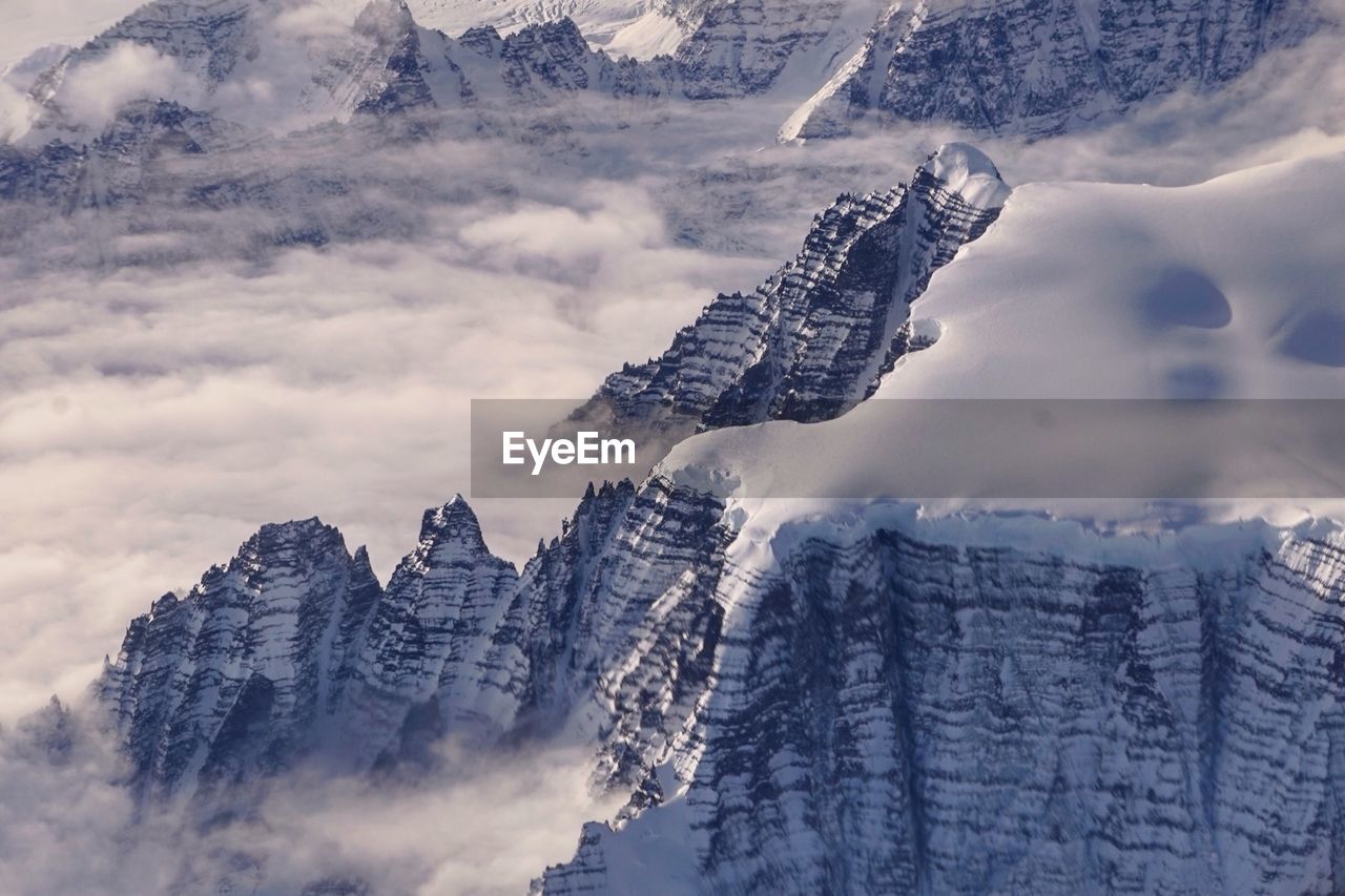 Panoramic view of snowcapped mountains against sky