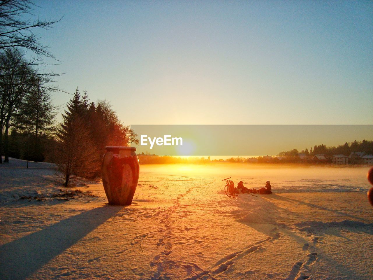 Scenic view of beach against clear sky during sunset