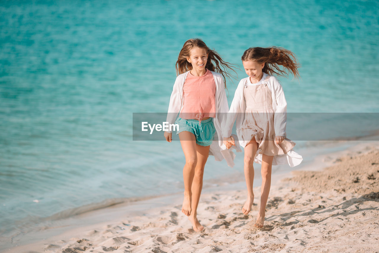 FULL LENGTH OF MOTHER ON BEACH