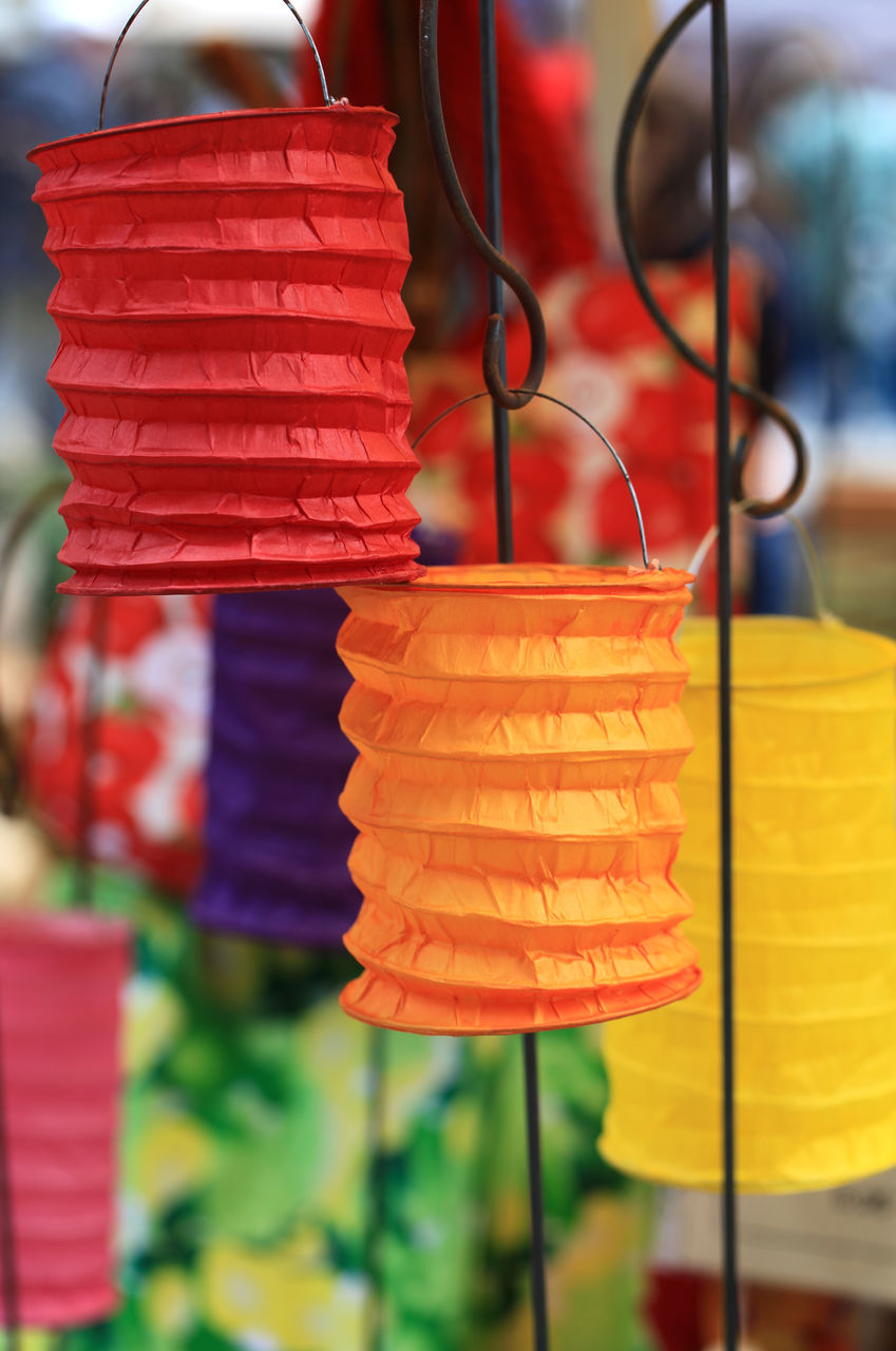 Close-up of multi colored lanterns hanging for sale at market stall