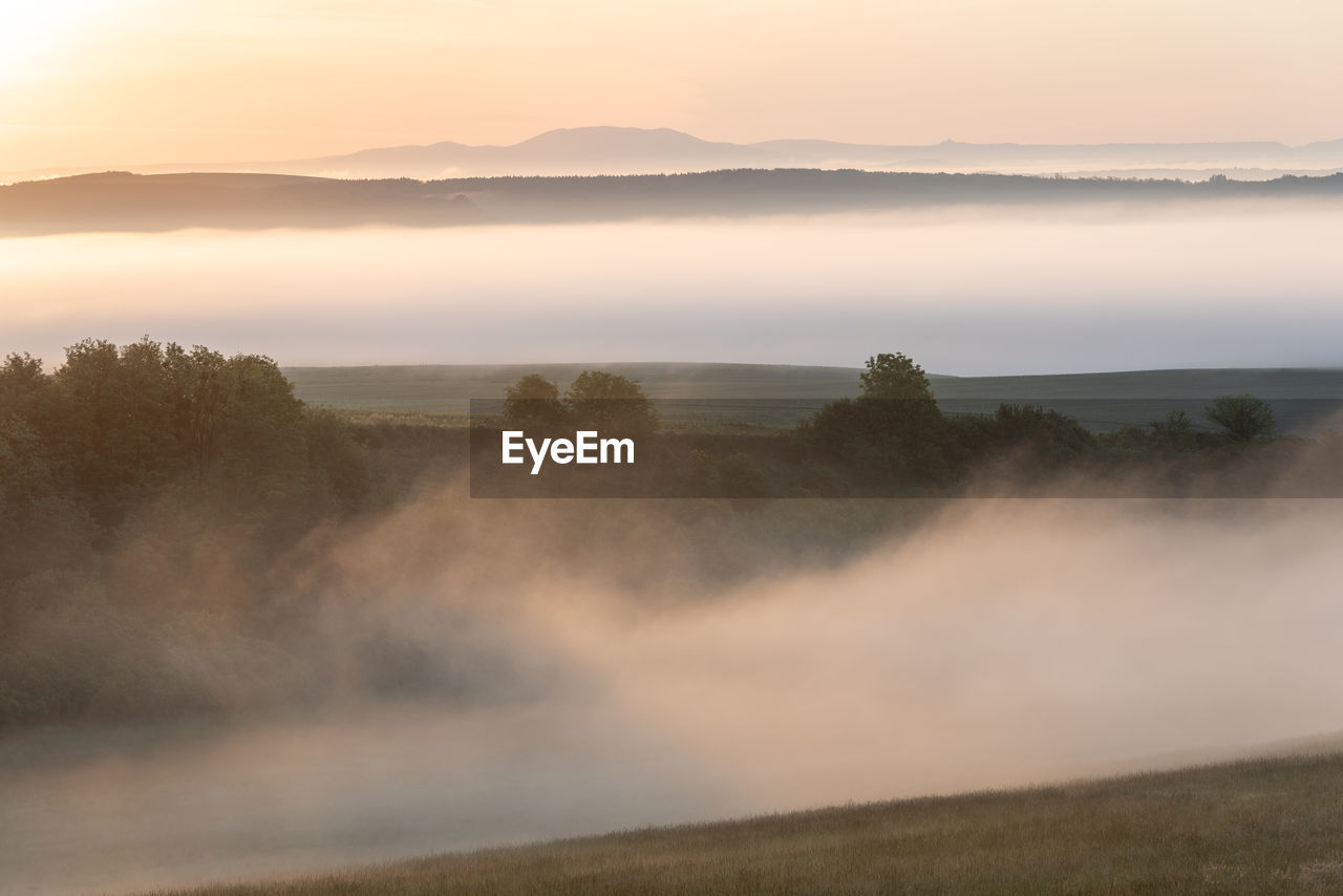 Scenic view of landscape against sky during sunset